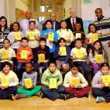Students holding dictionaries provided through local sponsorship